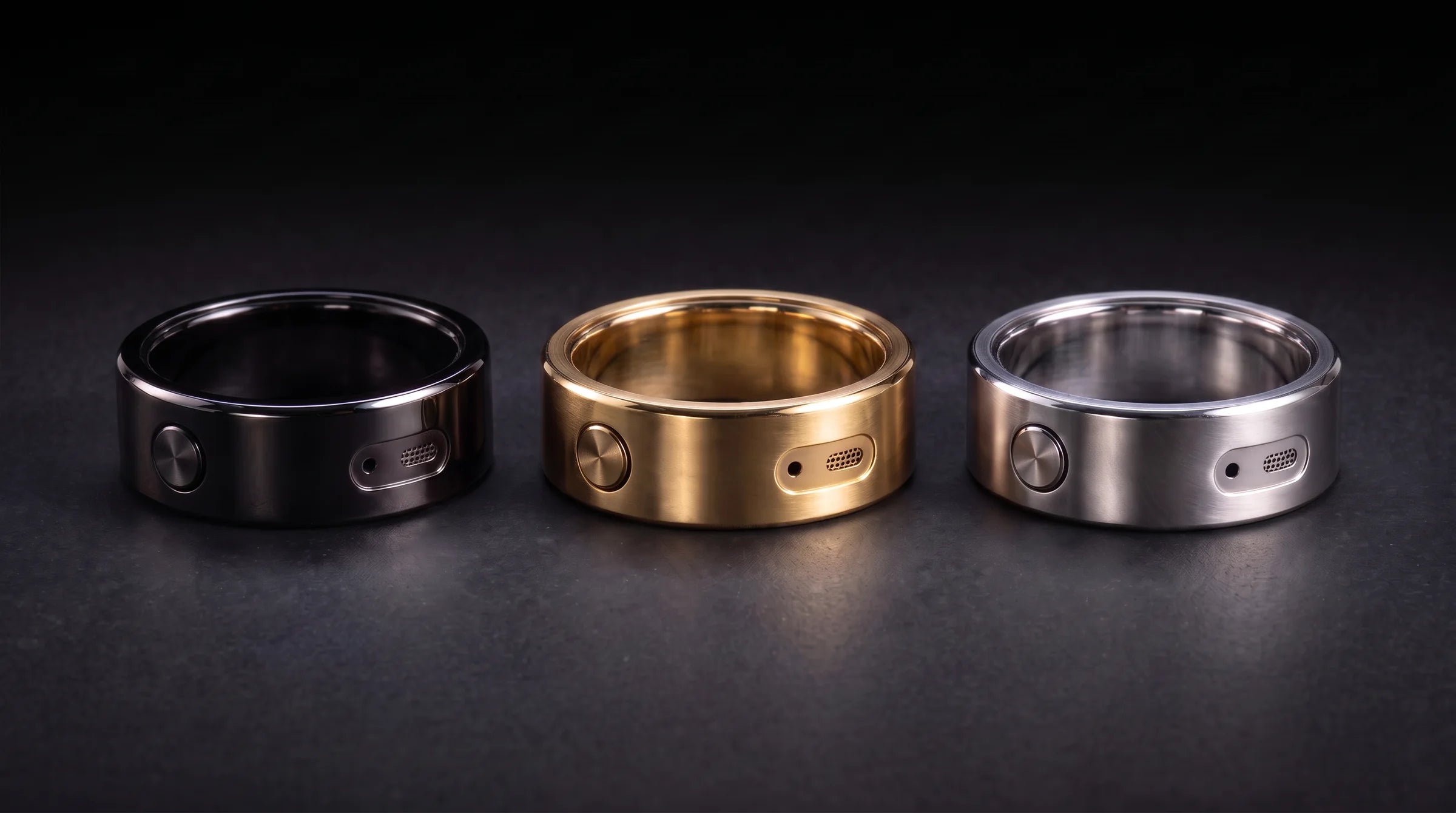 The Revaudo AI Ring in black, gold and silver on dark stone
